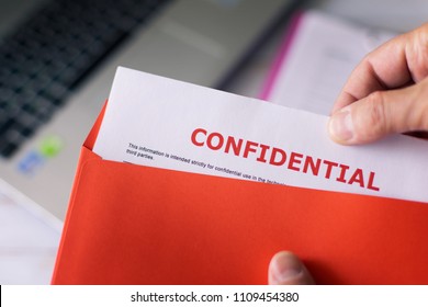 man-opens-red-letter-confidential-260nw-1109454380